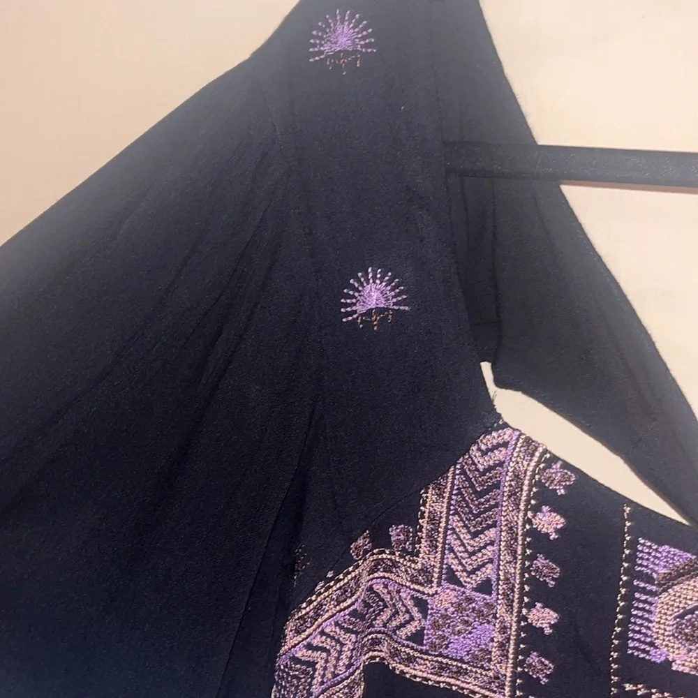 Free People black mini dress size XS with back tie and deep V bk w/ embroidery